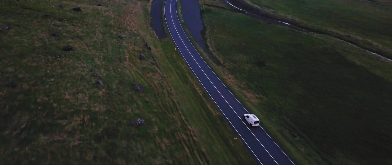 an aerial view of a truck driving down a road